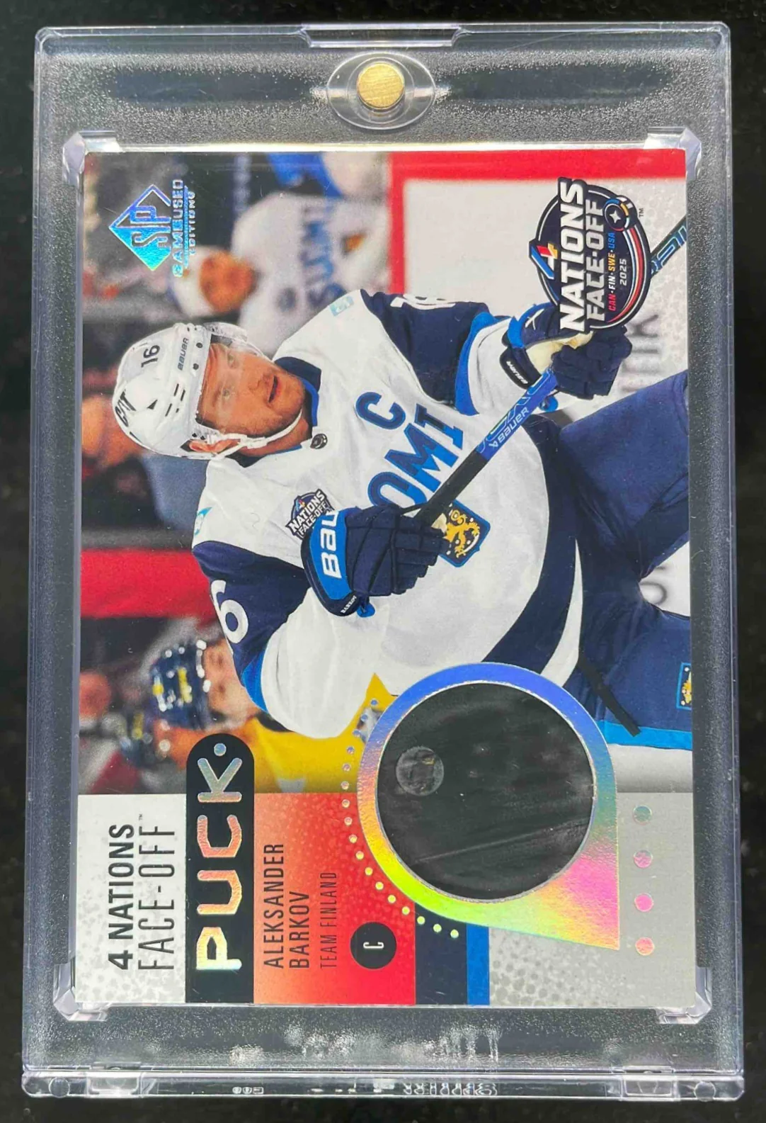 2025-26 SP Game Used Nations Face Off Puck Relics #4NP-AB Aleksander Barkov